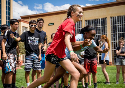 group of high school students compete in field game race