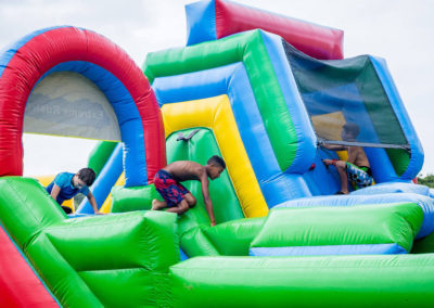 boys crawl through inflatable obstacle course
