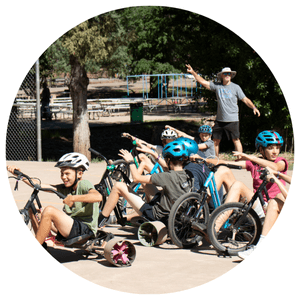 group of people on large wheeled trikes playing a game