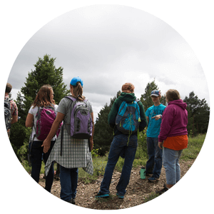 group of people on a walking path with an overlook view