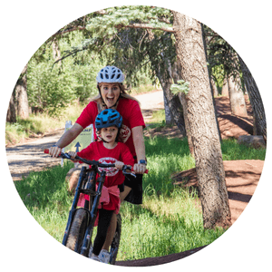 mom and daughter smiling on a scooter