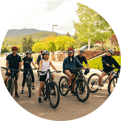 group walking in the woods wearing backpacks